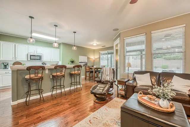 a living room with lots of furniture and kitchen view