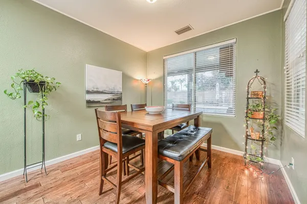 a dining room with furniture and wooden floor