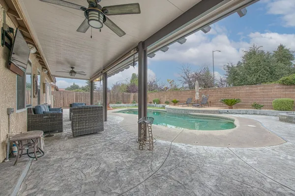 a view of a porch with furniture and a yard