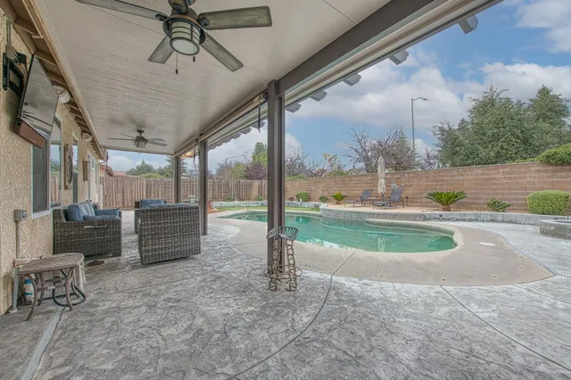 a view of a porch with furniture and a yard
