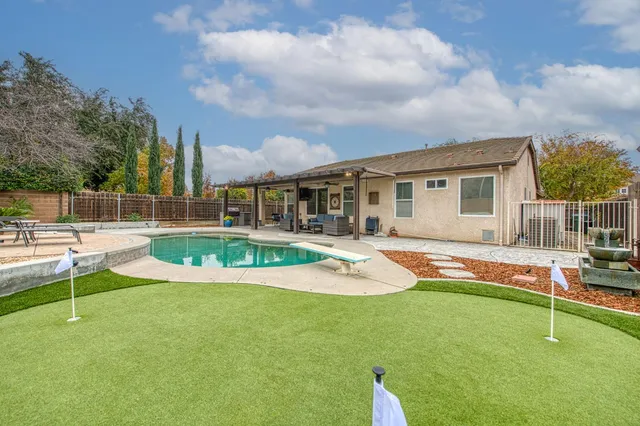 a view of a house with swimming pool and porch