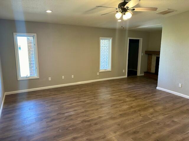 9223 County Road 6700 Lubbock, TX 79403 - Photo 21 of 60 an empty room with wooden floor and windows