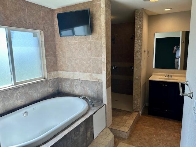 9223 County Road 6700 Lubbock, TX 79403 - Photo 24 of 60 a bathroom with a tub and a double vanity sink
