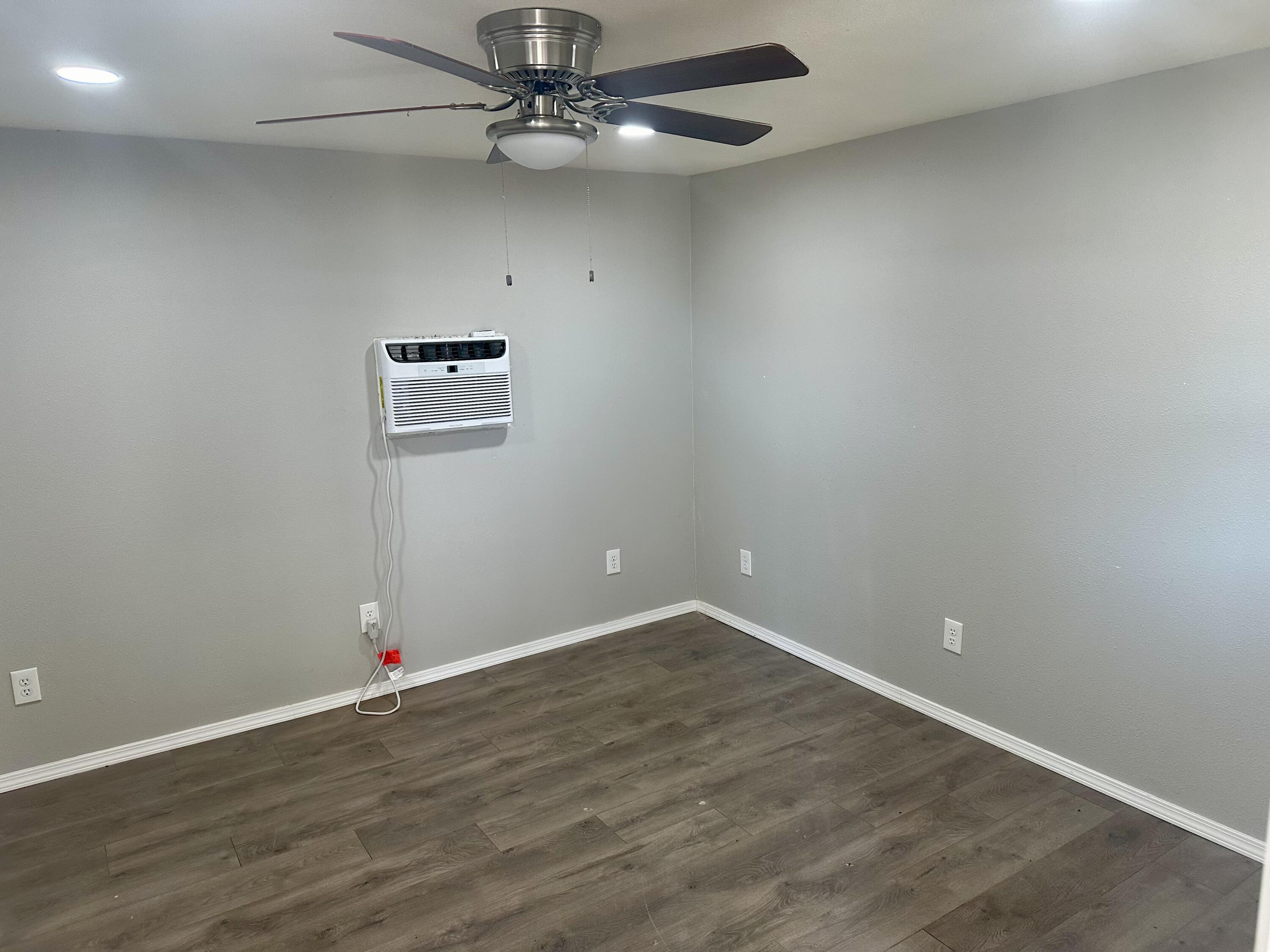 9223 County Road 6700 Lubbock, TX 79403 - Photo 30 of 60 an empty room with wooden floor
