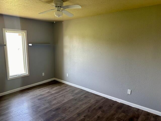 9223 County Road 6700 Lubbock, TX 79403 - Photo 3 of 60 an empty room with wooden floor and windows