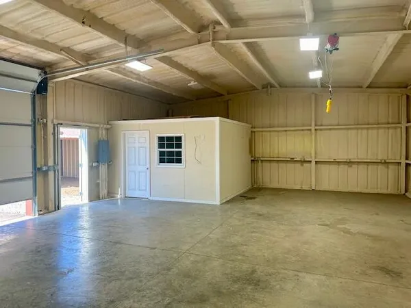 a view of a field with fence in background