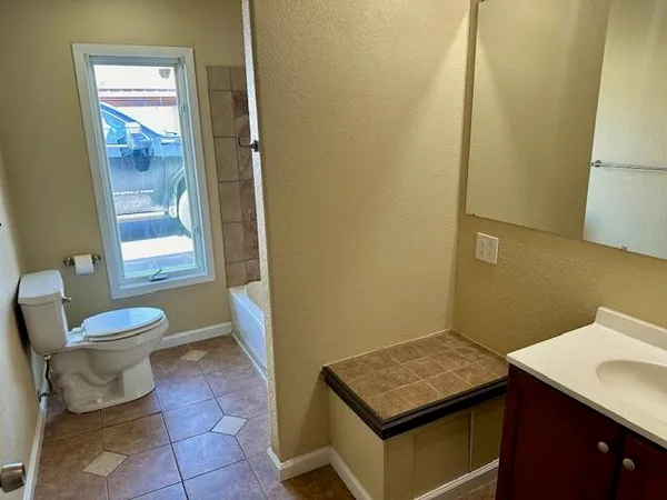 a bathroom with a toilet a sink and a mirror