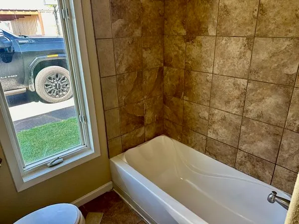 a bathroom with a bath tub and a window