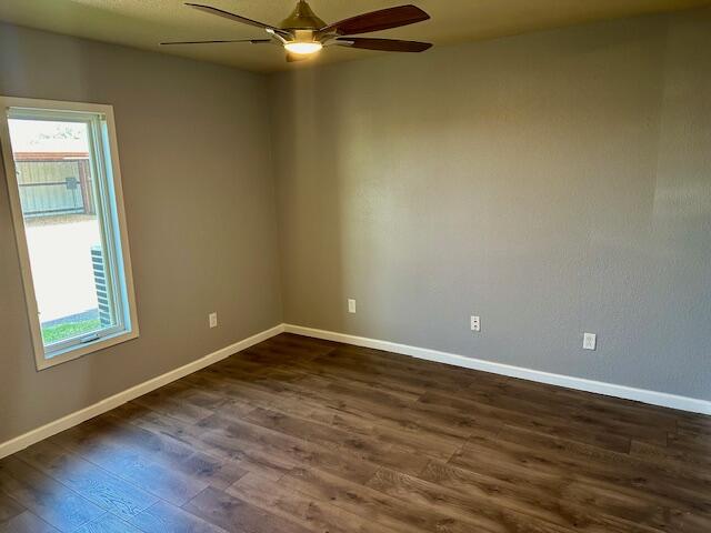 9223 County Road 6700 Lubbock, TX 79403 - Photo 9 of 60 an empty room with wooden floor and windows