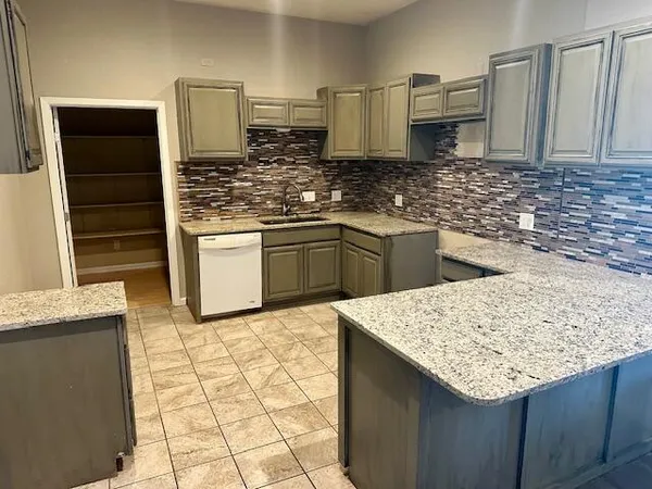 a kitchen with stainless steel appliances kitchen island granite countertop a sink stove and cabinets