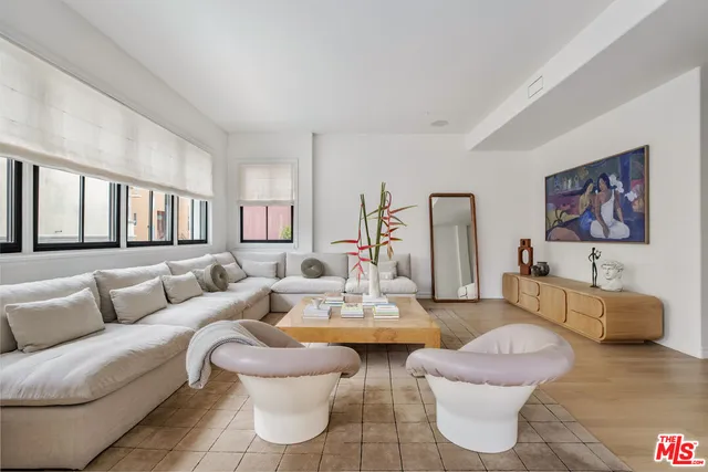 a living room with furniture a rug and a table