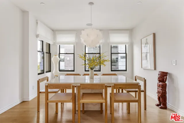 a dining room with wooden floor and breakfast area