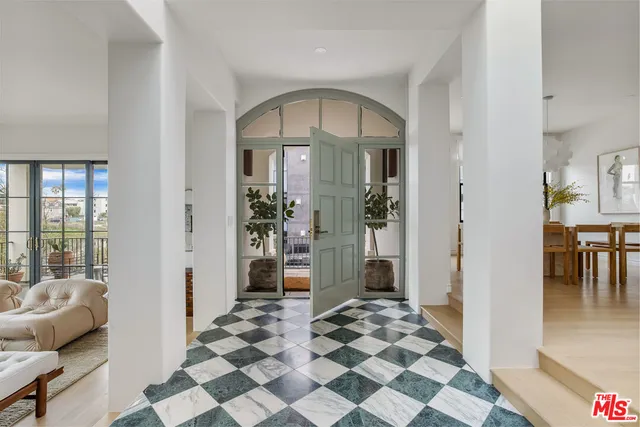 a view of a bedroom with furniture and window