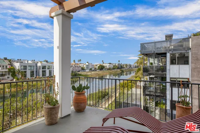 a view of a balcony with lake view and a floor to ceiling window