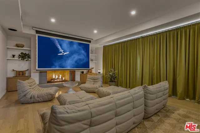 a bed room with furniture and a flat screen tv