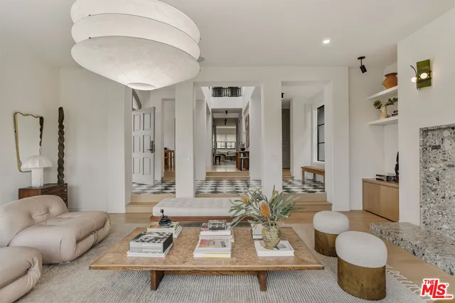 a living room with furniture and a chandelier