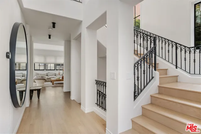 a view of entryway and hall with wooden floor