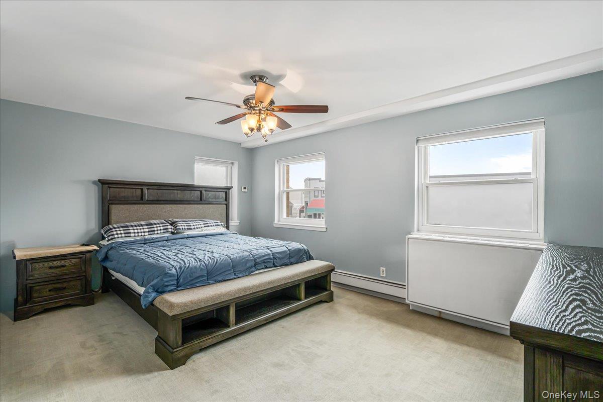 10 Lenox Road, Unit 2F Rockville Centre, NY 11570 - Photo 11 of 21 a bedroom with a bed and a chandelier
