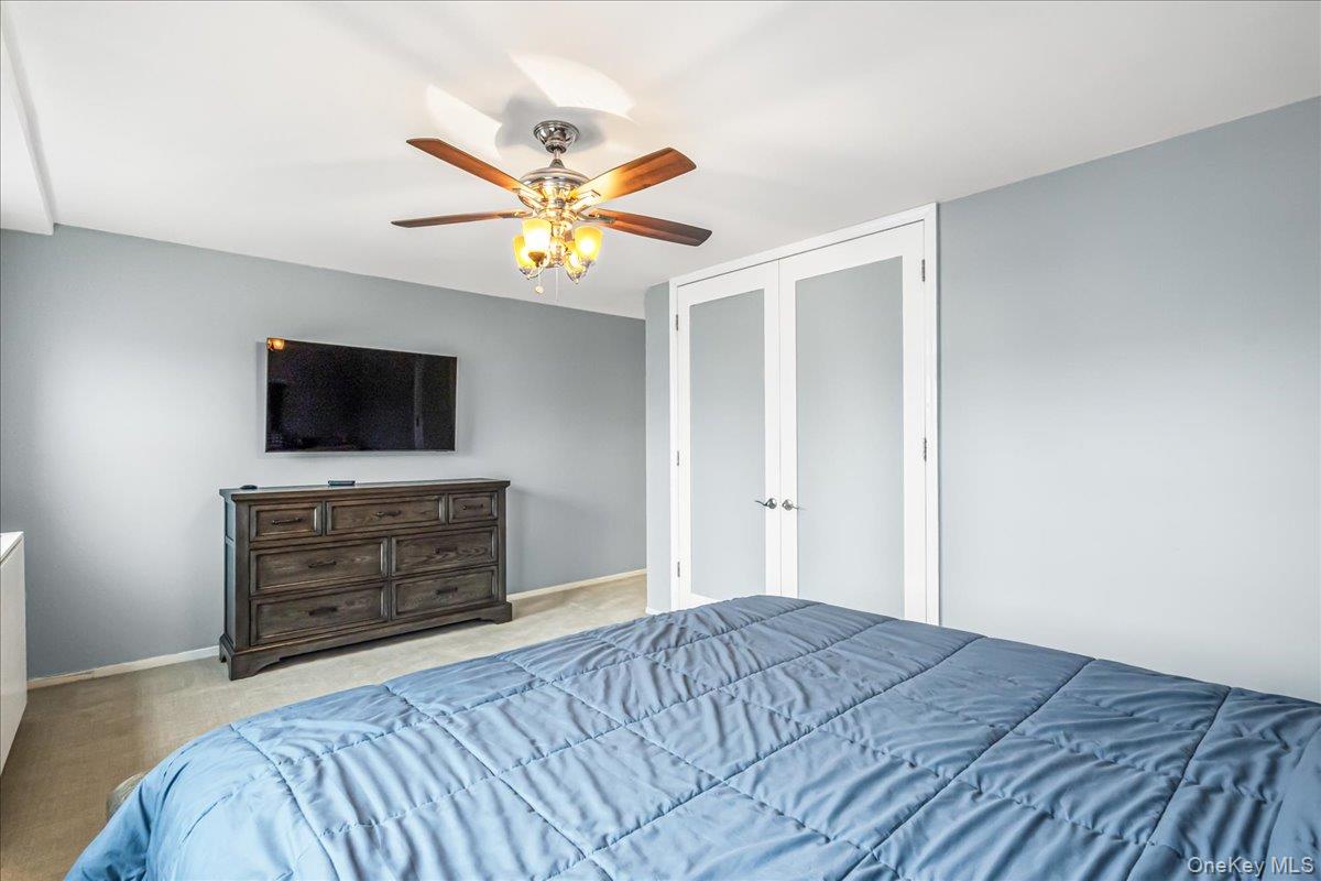 10 Lenox Road, Unit 2F Rockville Centre, NY 11570 - Photo 12 of 21 a bedroom with a bed and a flat screen tv