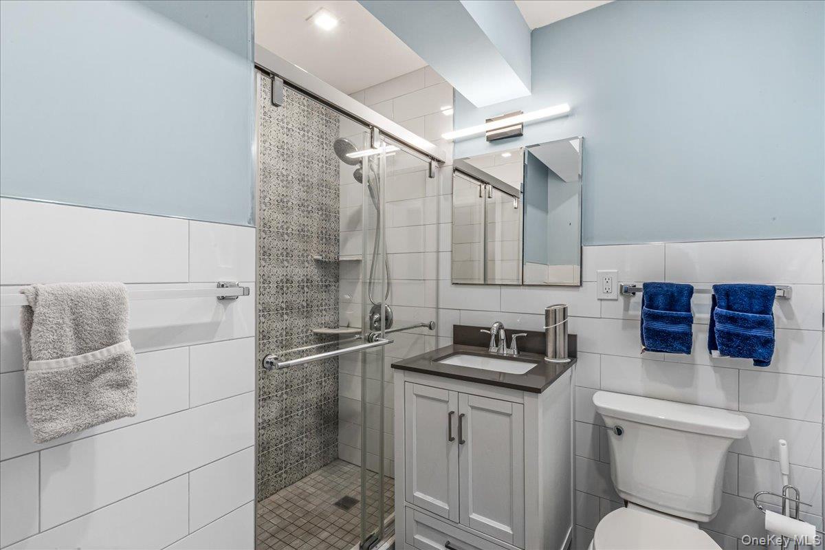 10 Lenox Road, Unit 2F Rockville Centre, NY 11570 - Photo 14 of 21 a bathroom with a sink and a mirror