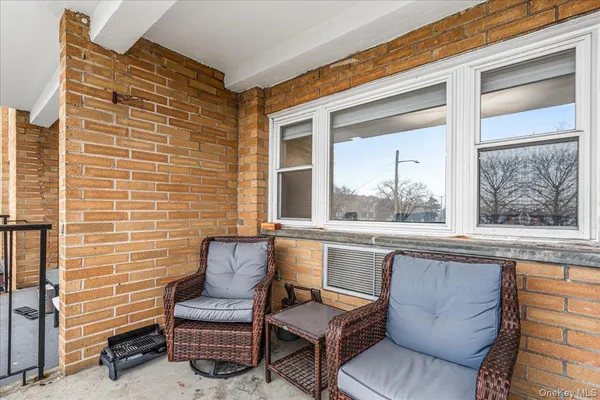 a view of a two chairs in the balcony