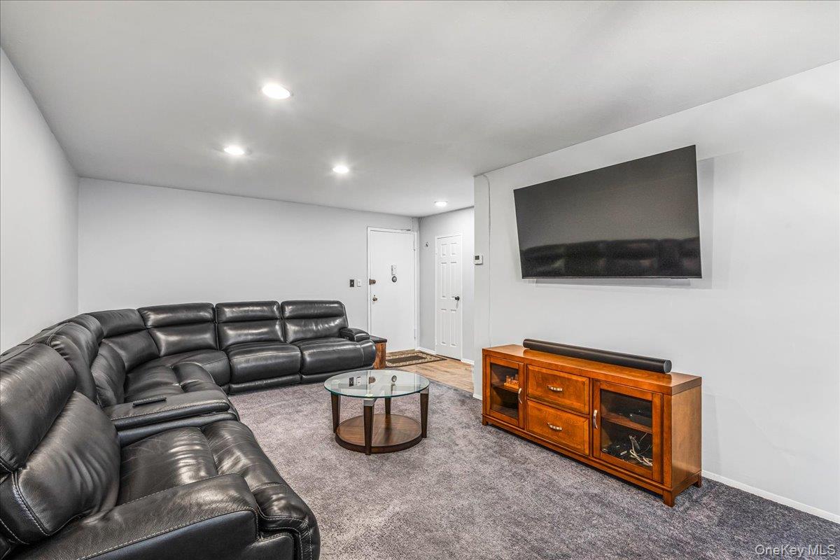 10 Lenox Road, Unit 2F Rockville Centre, NY 11570 - Photo 5 of 21 a living room with furniture and a flat screen tv