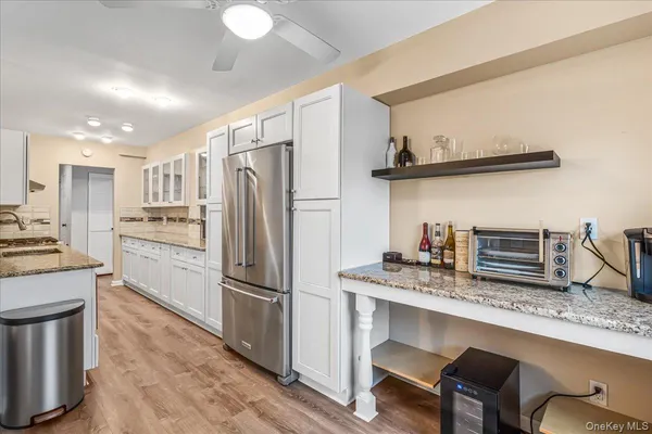 a kitchen with refrigerator and chairs