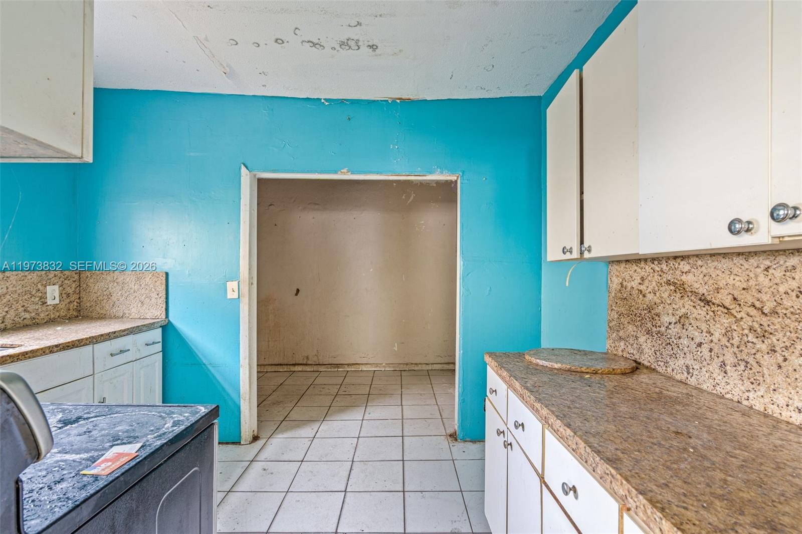1045 Southwest 20th Avenue Miami, FL 33135 - Photo 12 of 53 a kitchen with a sink a stove top oven and cabinets