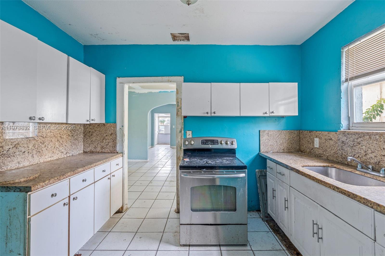 1045 Southwest 20th Avenue Miami, FL 33135 - Photo 14 of 53 a kitchen with a sink cabinets and appliances