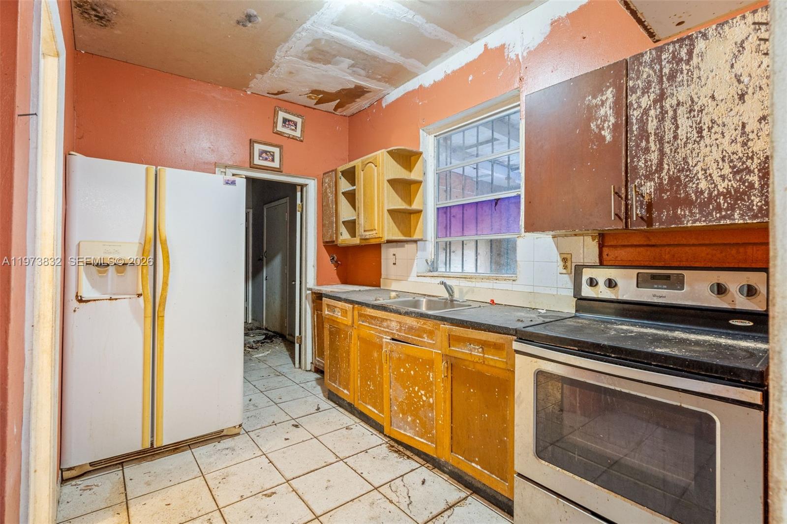 1045 Southwest 20th Avenue Miami, FL 33135 - Photo 30 of 53 a kitchen with stainless steel appliances granite countertop a stove a sink and a refrigerator