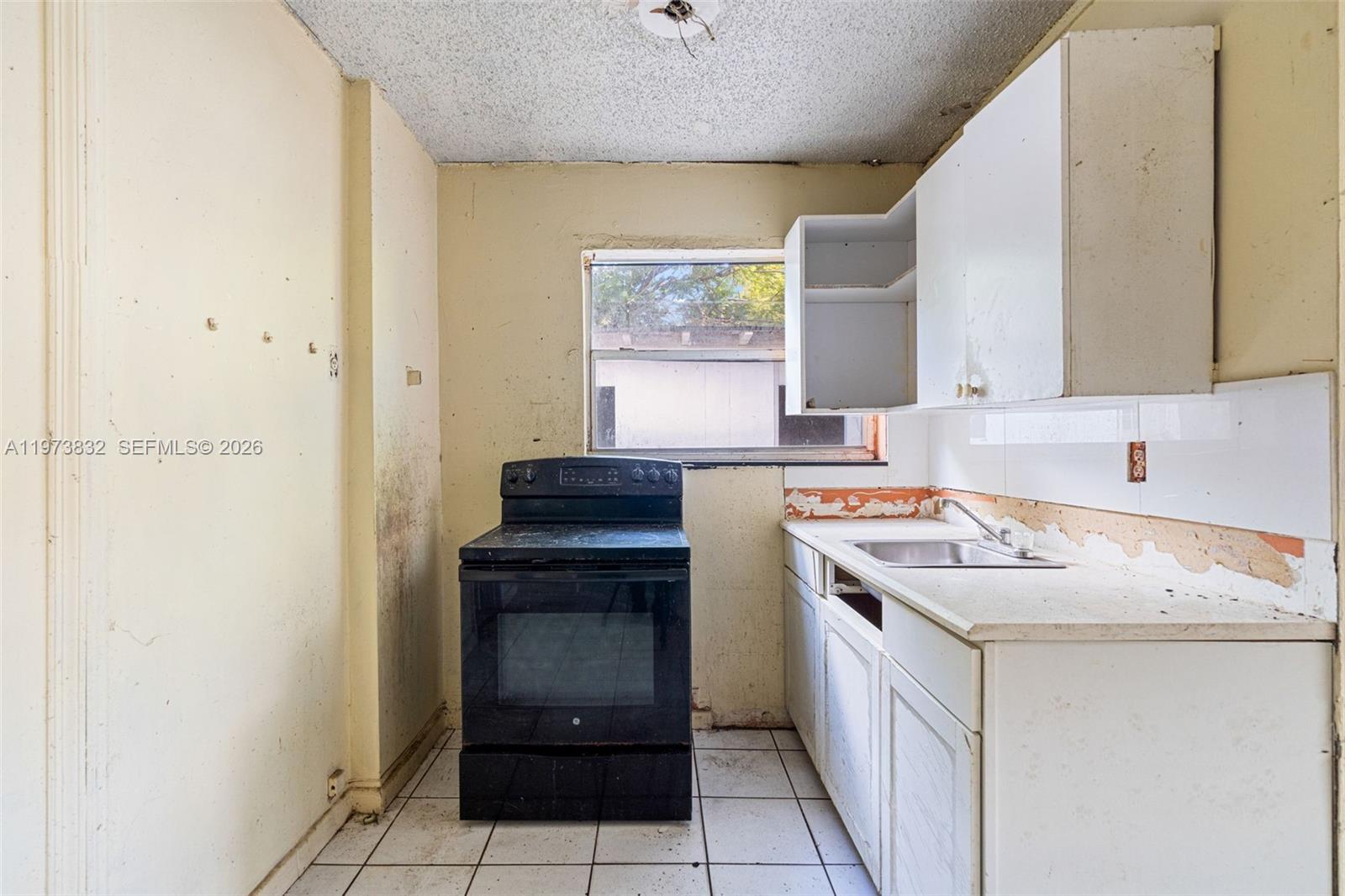 1045 Southwest 20th Avenue Miami, FL 33135 - Photo 39 of 53 a kitchen with a stove sink and cabinets