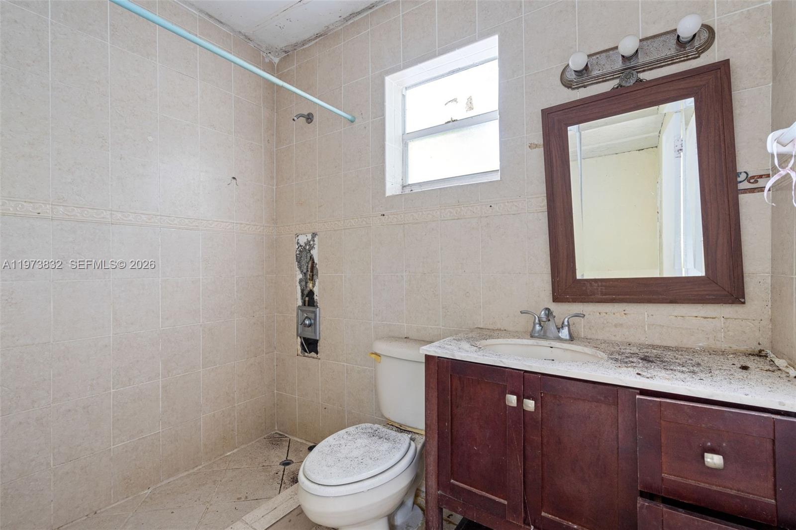 1045 Southwest 20th Avenue Miami, FL 33135 - Photo 42 of 53 a bathroom with a granite countertop toilet a sink and mirror