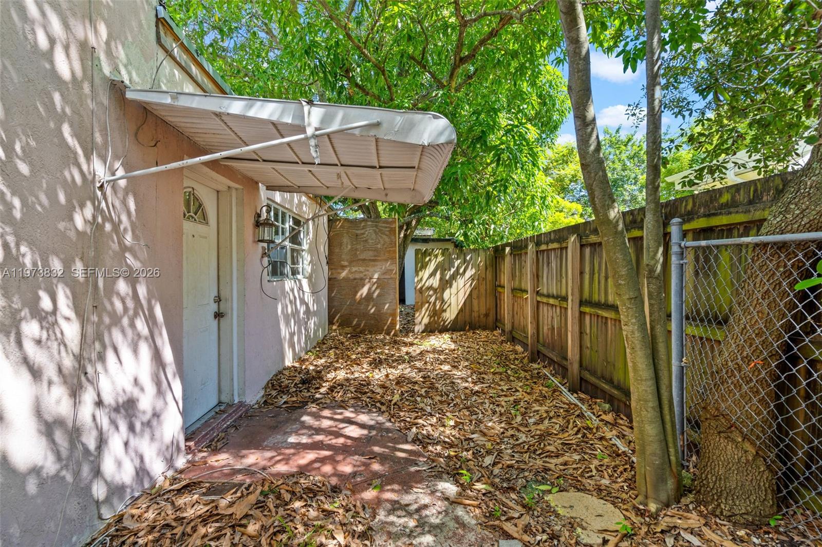 1045 Southwest 20th Avenue Miami, FL 33135 - Photo 46 of 53 a view of a yard with wooden fence