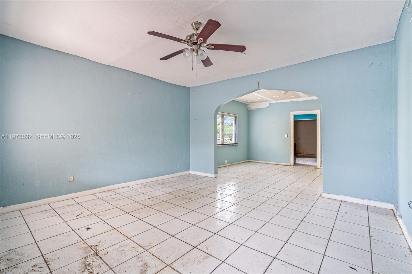 1045 Southwest 20th Avenue Miami, FL 33135 - Photo 7 of 53 a view of a livingroom with a chandelier fan and windows