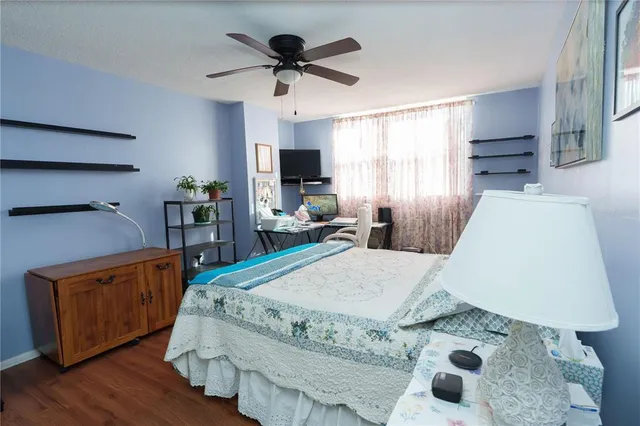 a bed room with a bed furniture and a flat tv screen