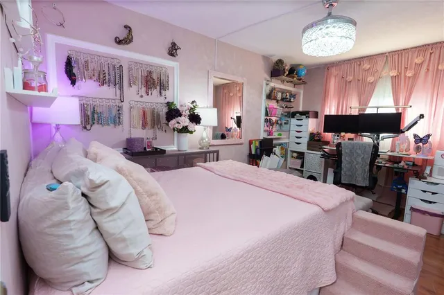 a bed room with a bed mirror and a table