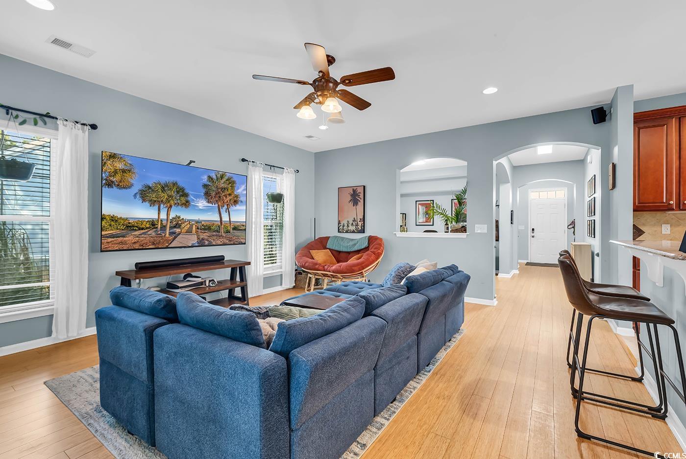 1005 Elysium Court Murrells Inlet, SC 29576 - Photo 11 of 37 Living area with arched walkways, recessed lighting, ceiling fan, and light wood-style floors