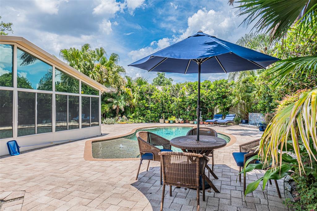 741 Brookside Road Maitland, FL 32751 - Photo 24 of 43 a patio with a table and chairs under an umbrella