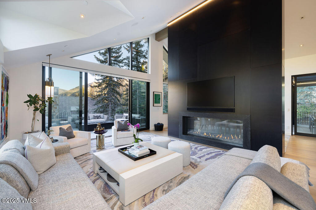 254 Beaver Dam Road Vail, CO 81657 - Photo 8 of 46 a living room with furniture a flat screen tv and a large window