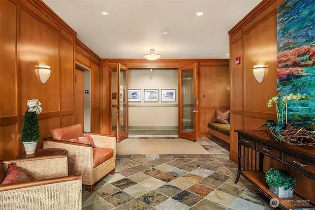 a lobby with furniture and potted plants