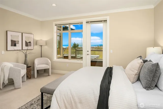 a bedroom with a bed and next to a window