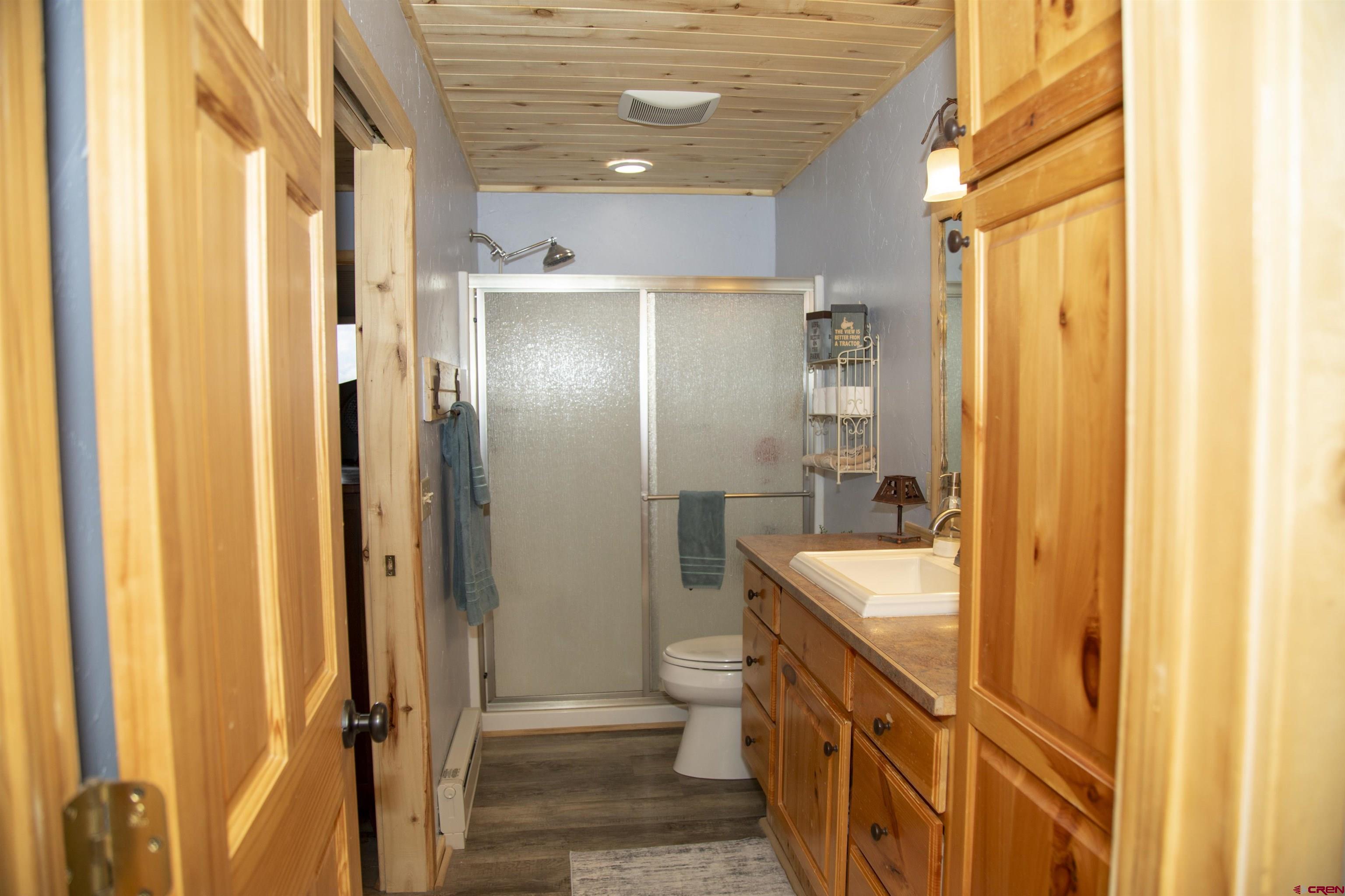 258 Diamond Road Creede, CO 81130 - Photo 11 of 30 a bathroom with a tub a sink and a large mirror