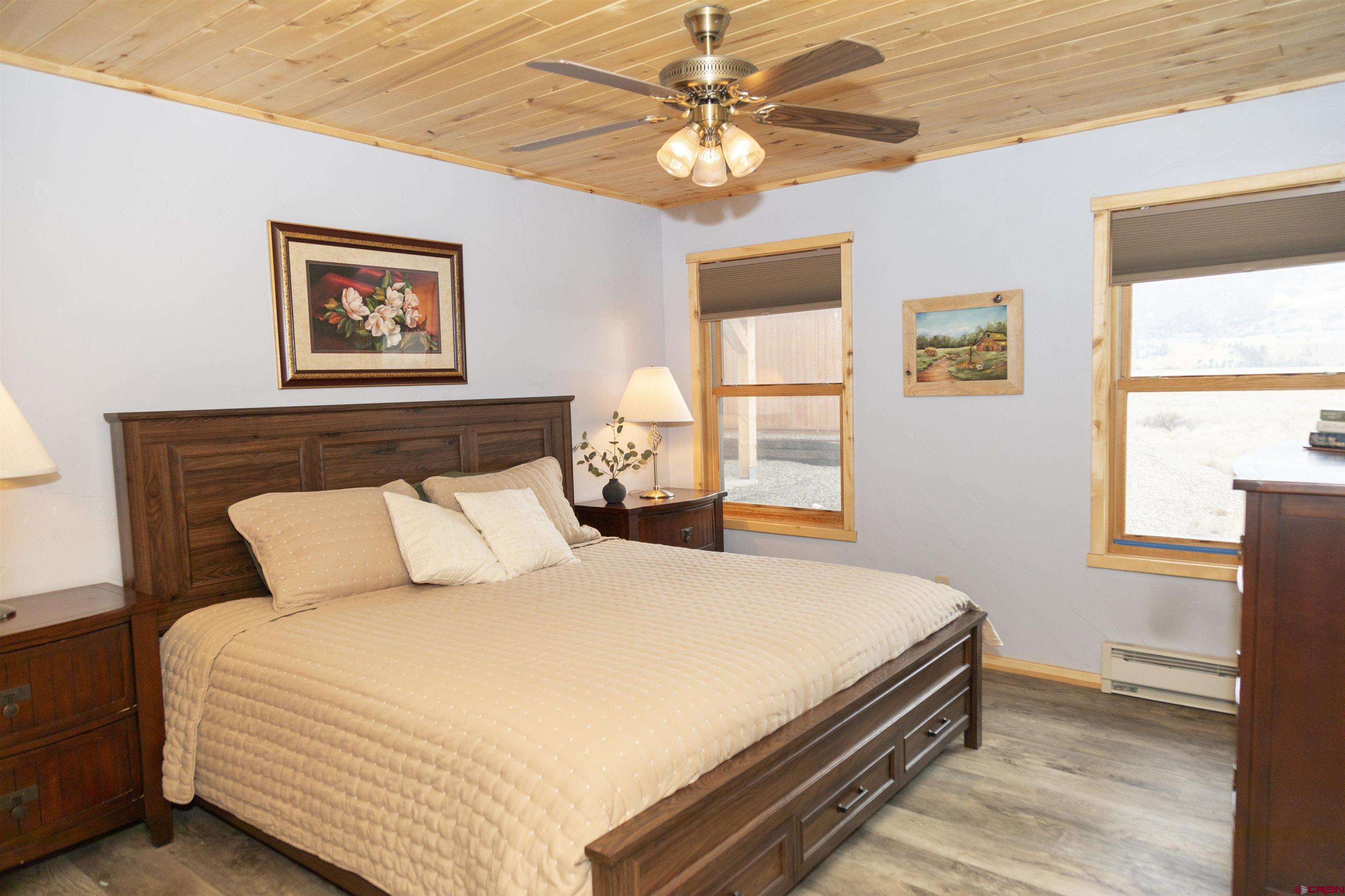 258 Diamond Road Creede, CO 81130 - Photo 12 of 30 a bedroom with a bed and a chandelier
