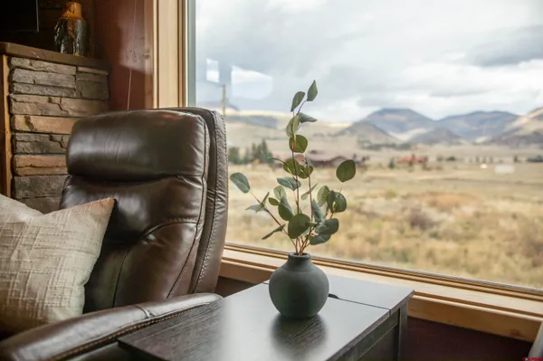 a living room with furniture and a floor to ceiling window