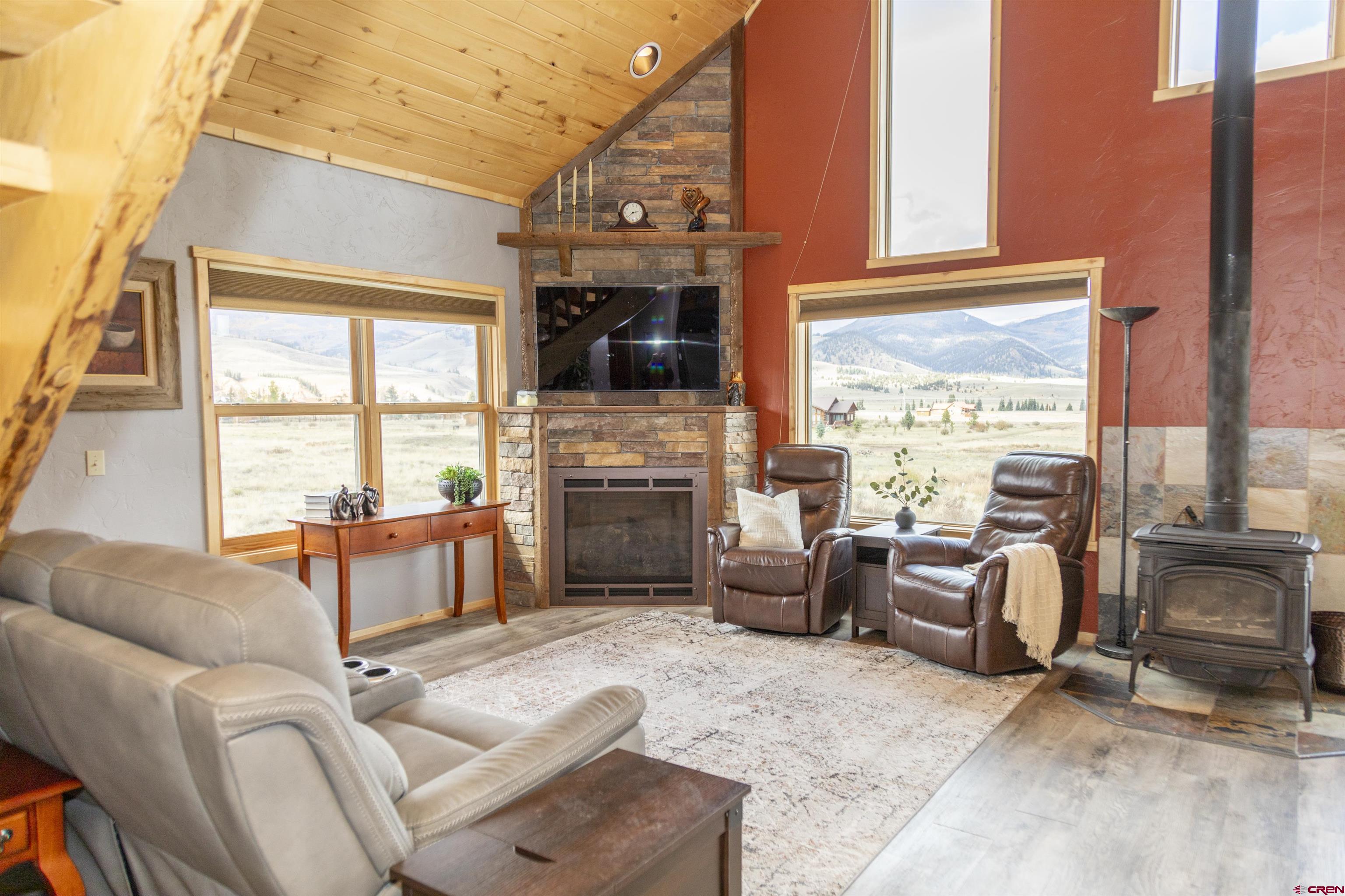 258 Diamond Road Creede, CO 81130 - Photo 19 of 30 a living room with furniture a fireplace and a flat screen tv