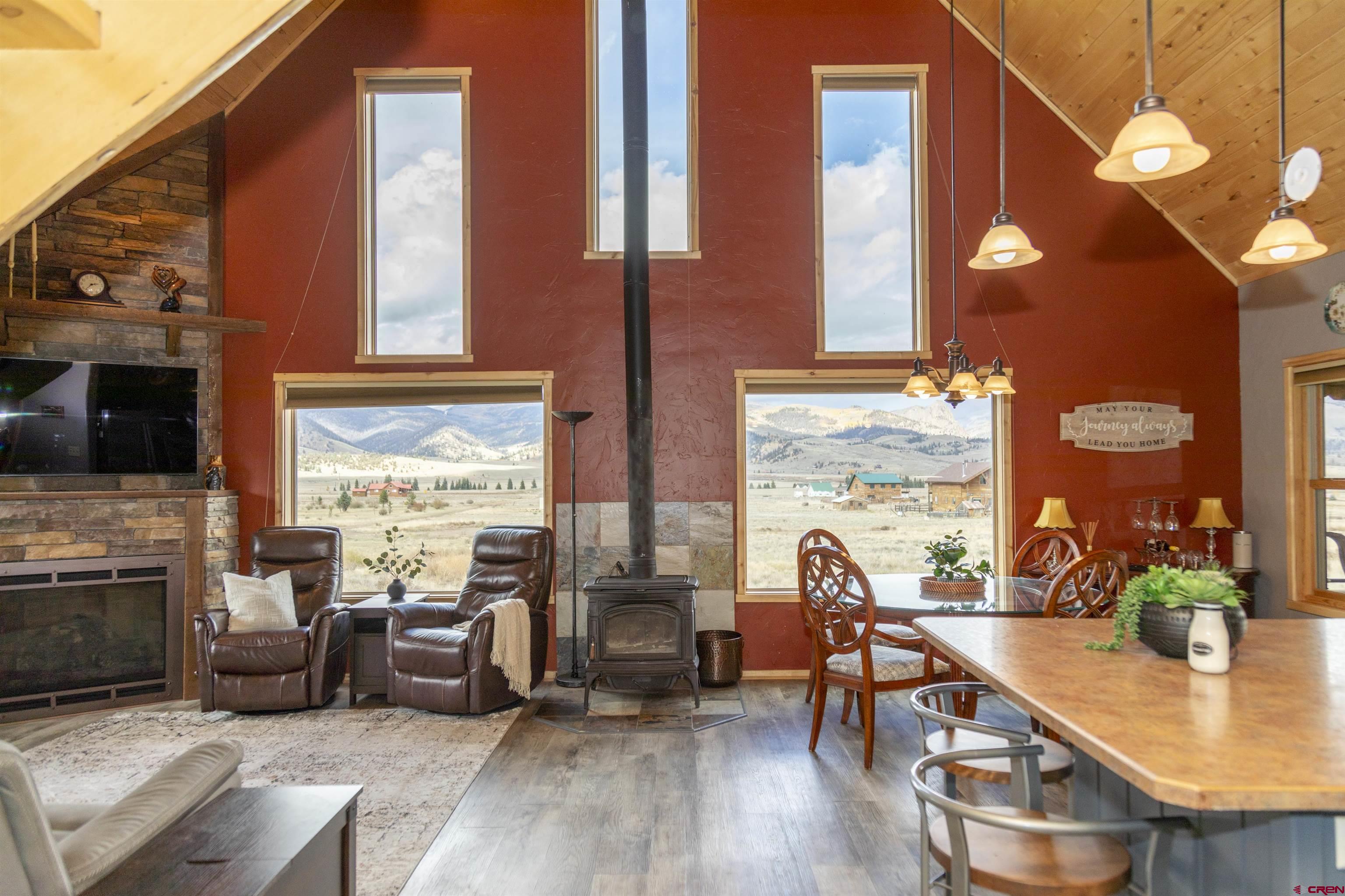 258 Diamond Road Creede, CO 81130 - Photo 30 of 30 a living room with furniture a fireplace and potted plants