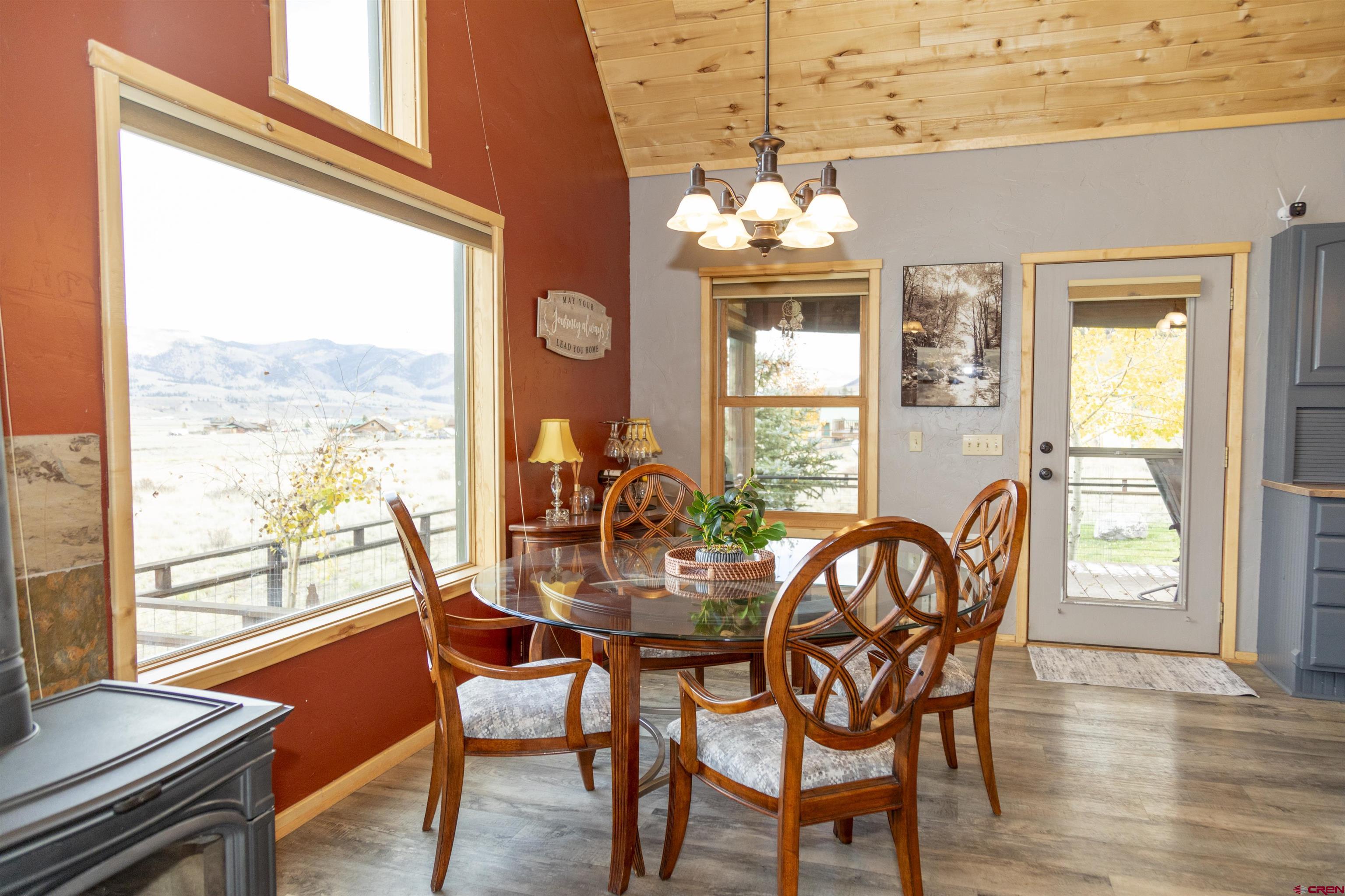 258 Diamond Road Creede, CO 81130 - Photo 7 of 30 a view of a dining room with furniture a chandelier and wooden floor