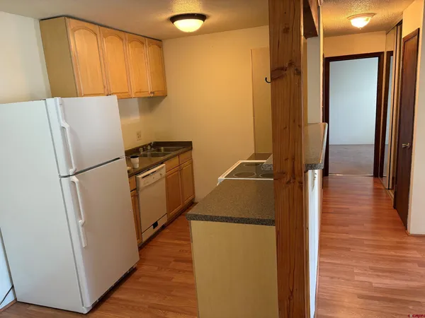 a utility room with wooden floor washer and dryer