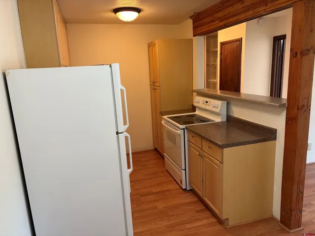 an empty room with wooden floor and a window