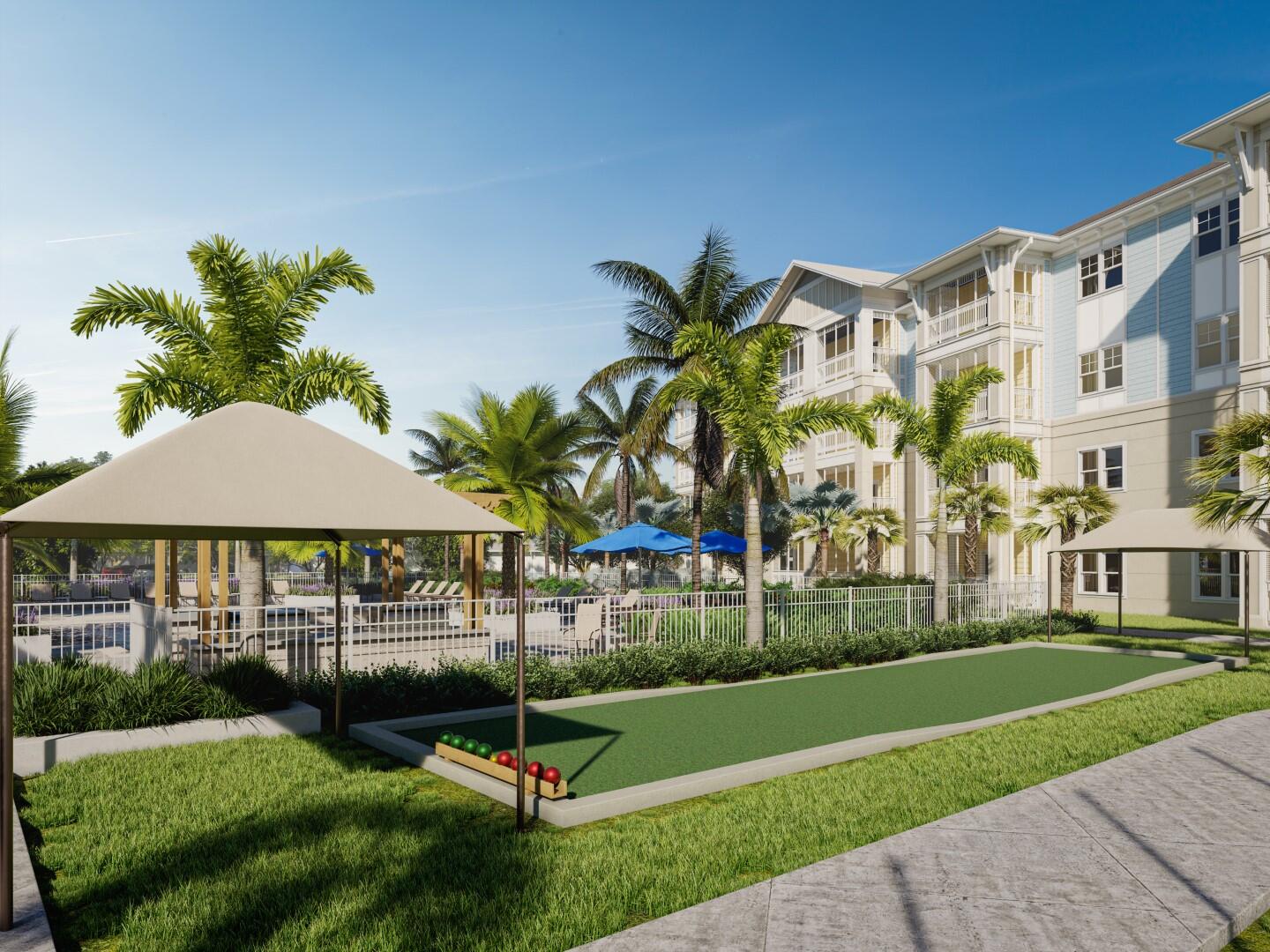 1916 Northwest Federal Highway, Unit 3106 Stuart, FL 34994 - Photo 12 of 26 a garden with a bench in front of the house